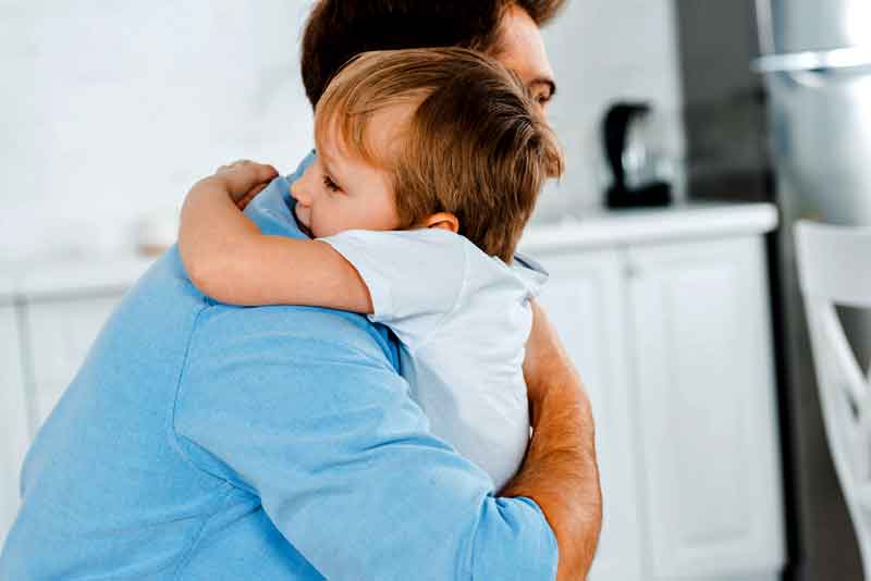 Dad and son hugging